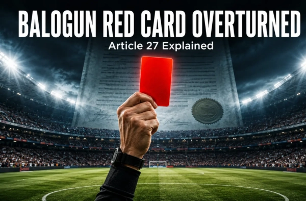 Referee's hand raising a red card in a floodlit stadium with a legal document behind it — Balogun red card overturned under FIFA's Article 27