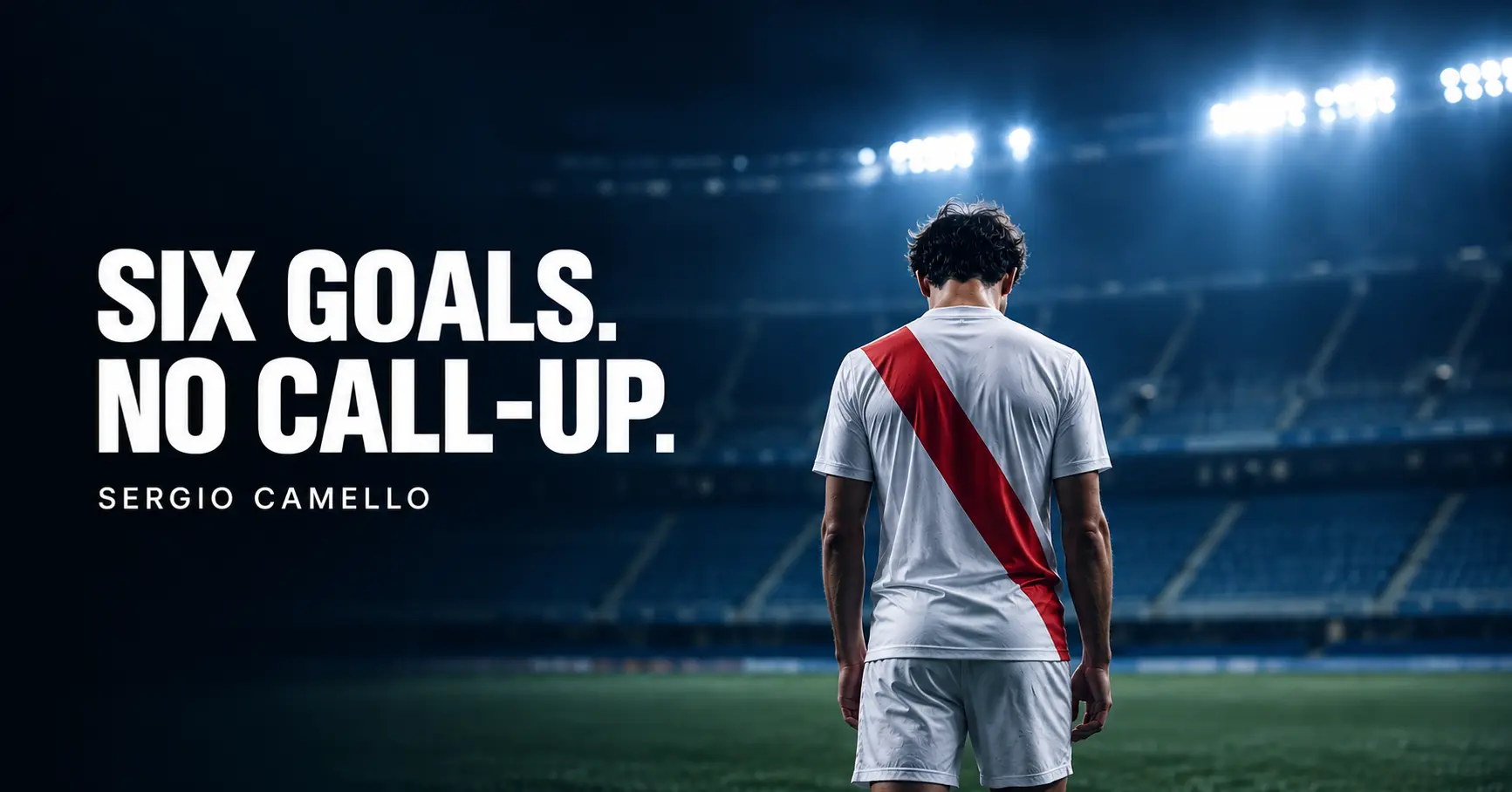 Football striker in a white shirt with a red sash standing alone in a floodlit stadium, illustrating the Sergio Camello Spain squad snub